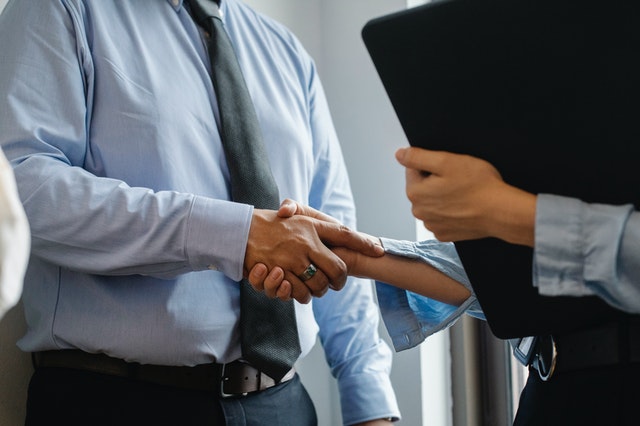 business man and business woman shaking hands